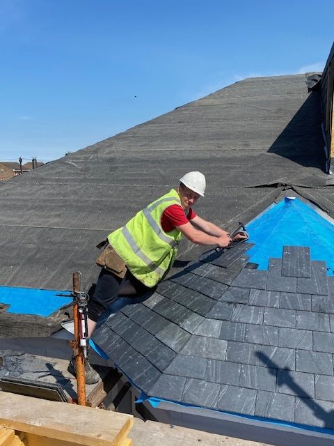 A picture of a roofer repairing and maintaining a slate roof in Edinburgh. Regular inspection and timely remedial work will save you money and protect your home from more problematic issues developing.